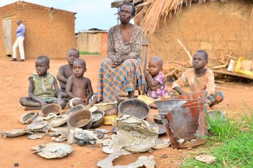 Anek Karamera with grandchildren and some of her destroyed possessions