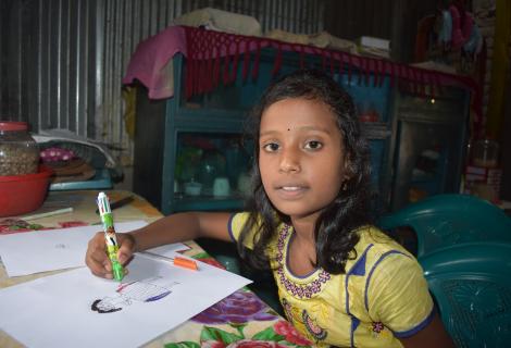 Photo of a nine year old c=girl called Sumaiya doing her homework