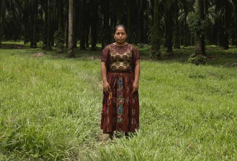 Woman stands in a field looking at the camera