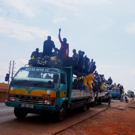 The photo shows members of the Apaa community on an open-top bus