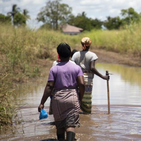 Women working through flooded path