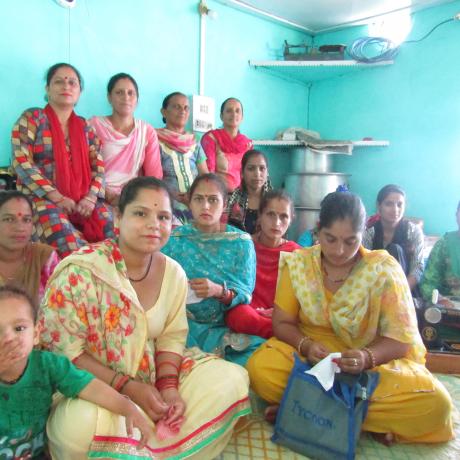 Women taking part in a village women’s right forum in India