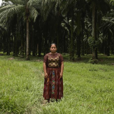 Woman stands in a field looking at the camera