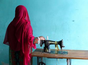 Rahima, with her sewing machine