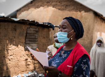 A woman responder wearing a protective face mask