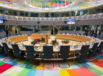 Inside the EU Council, roundtable with chairs and a multicoloured carpet 