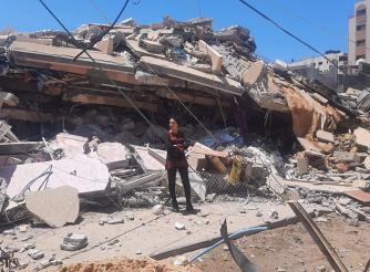 Samah Kassab is a senior programme officer at ActionAid Palestine who lives in north-west Gaza. She is pictured among the devastation caused by Israeli airstrikes.