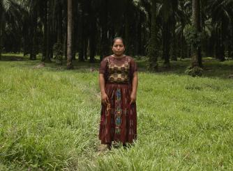 Woman stands in a field looking at the camera