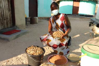 Mavis, 25, exhibits her crops grown through agroecology practices.